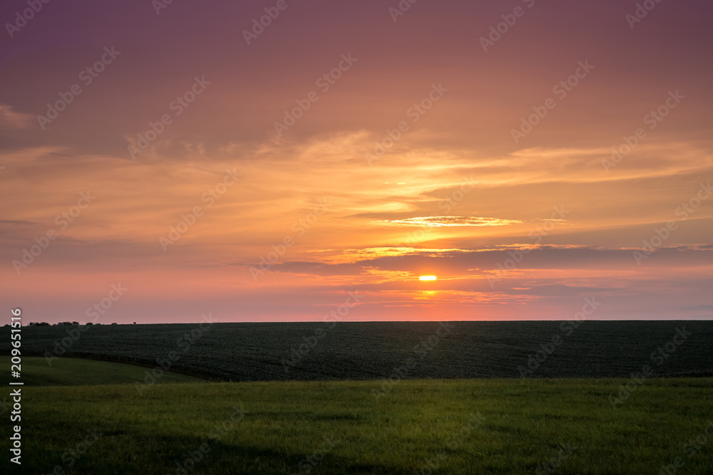 Scenic sunset on the plain. The dark sky during the sunset_