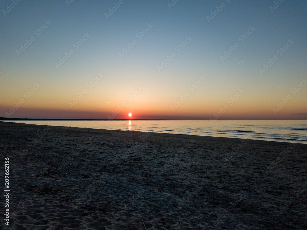 Fototapeta premium drone image. aerial view of red sunset in the sea. shore line