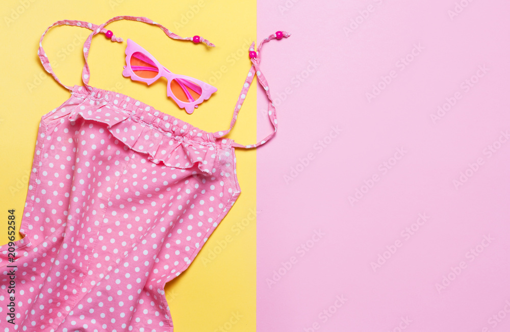 Pink summer dress on colorful background