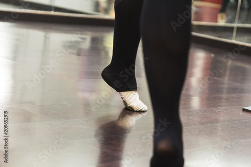 Ballerina dancing, closeup on legs and shoes.