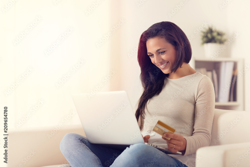 happy woman using laptop and buying online with credit card happy woman using laptop and buying online with credit card