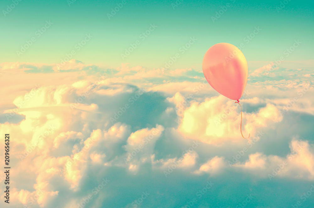 Pink air balloon flying high in the sky above the clouds, vintage process Pink air balloon flying high in the sky above the clouds, vintage process