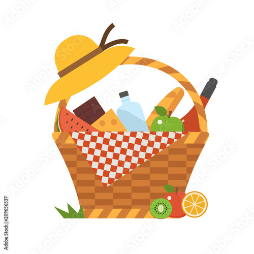 Wicker picnic basket with wine and french bread. Opened food hamper with blanket for romantic picnic.