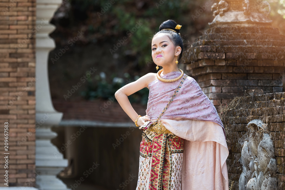 Closeup shot of bad mood Thai girl wearing thai traditional clothing.