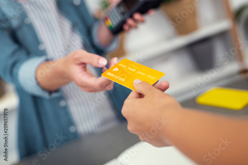 Non cash payment. Selective focus of a credit card being used for making non cash payment photo