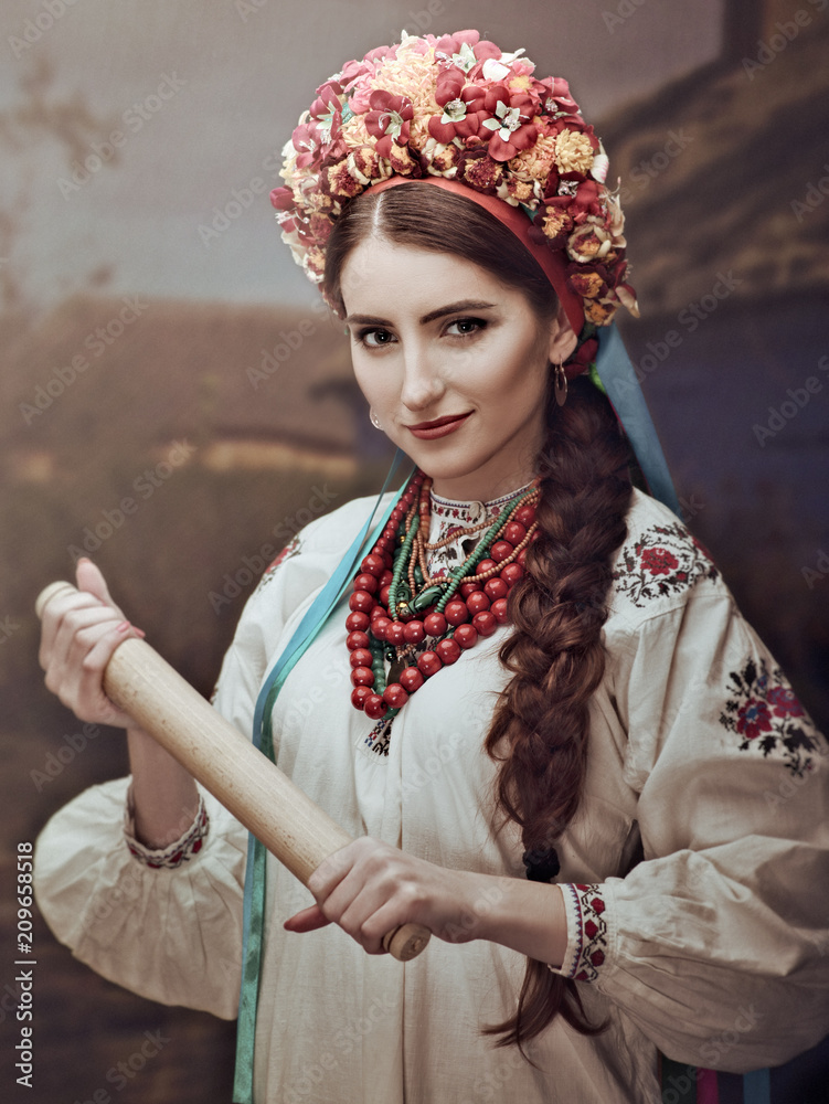 Ethno Beauty. Beautiful young woman in traditional ukrainian dress and crown