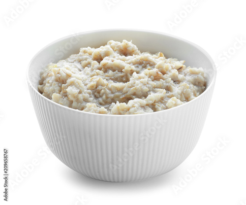 Tasty oatmeal in bowl on white background