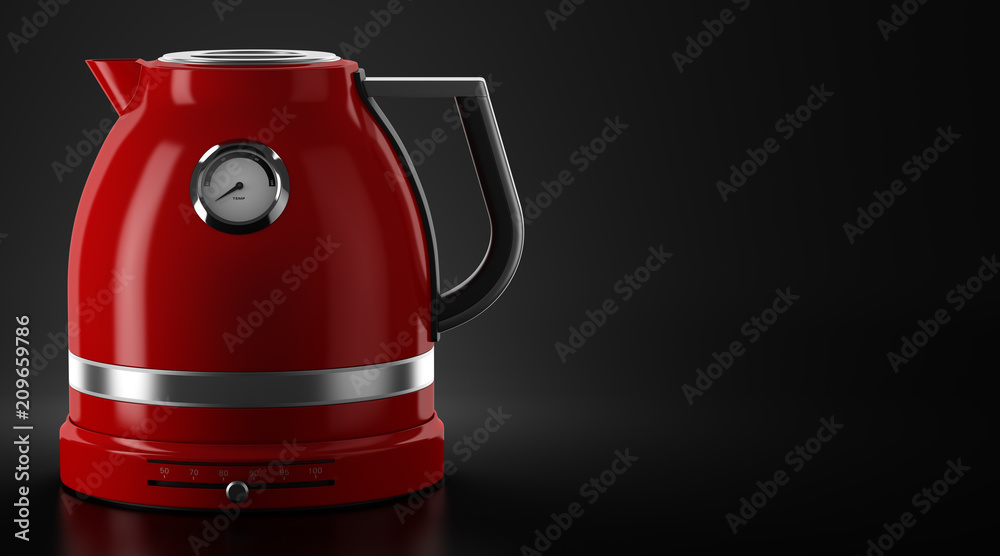 red electric kettle on black background with copyspace