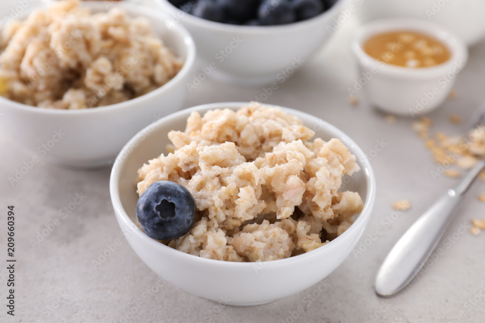 Bowl with tasty oatmeal and blueberry on table Bowl with tasty oatmeal and blueberry on table