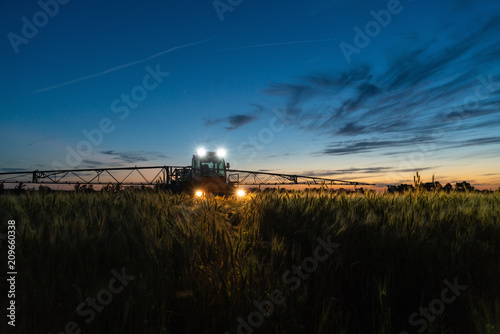Machine for spraying pesticides and herbicides on the field at night. 