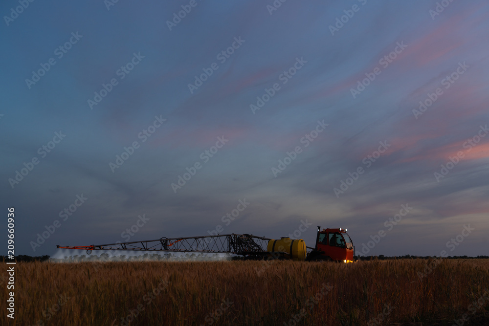 Fototapeta premium Machine for spraying pesticides and herbicides in the field at work