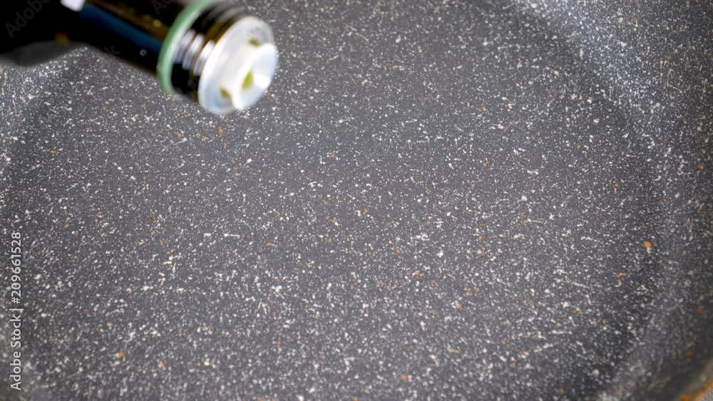 Pouring oil in pan for cooking. Closeup 4k Pouring oil in pan for cooking. Closeup 4k
