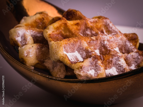Tradition Belgian crispy waffles with sugar powder, close-up