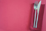 Beautiful cutlery on red background top view with copy space