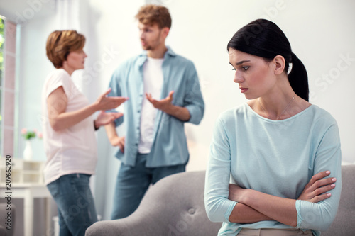 Sad mood. Nice young woman standing cross handed while feeling lonely