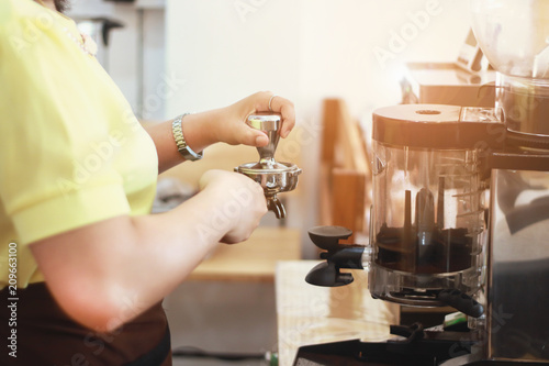 Barista using coffee machine in coffee shop counter Working woman small business owner food and drink cafe concept