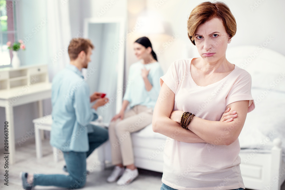Obraz premium I dont want. Depressed sad mother in law feeling unhappy while not approving her sons engagement