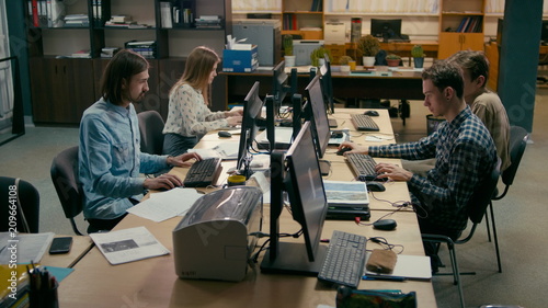 Young Casual Teamwork is Working at the Computers in the Busy Office