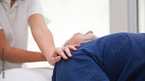 Stretching osteopathy or physiotherapy procedure in the neck photo