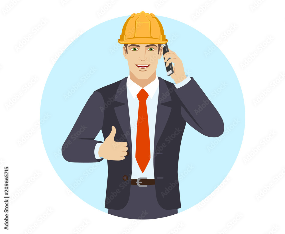 Businessman in construction helmet talking on the mobile phone and showing thumb up
