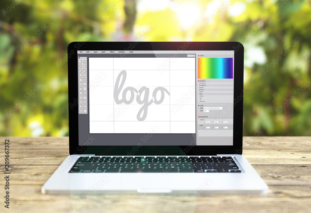 laptop wih logo design software on table laptop wih logo design software on table