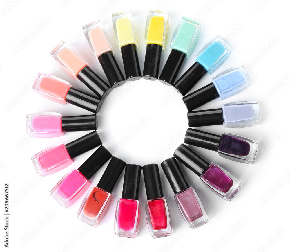Naklejka premium Frame made of bottles with colorful nail polishes on white background