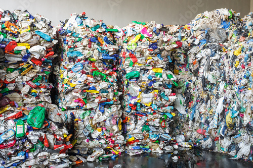 Plastic bales at the waste processing plant. Separate garbage collection. Recycling and storage of waste for further disposal. Business for sorting and processing of waste.