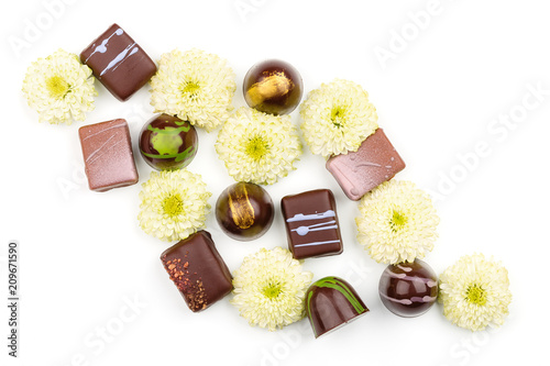 Top view of assortment chokolate bonbons with flowers on white background photo