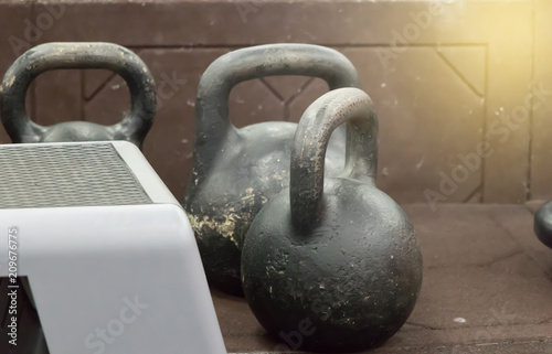 three same kettlebell on a floor photo