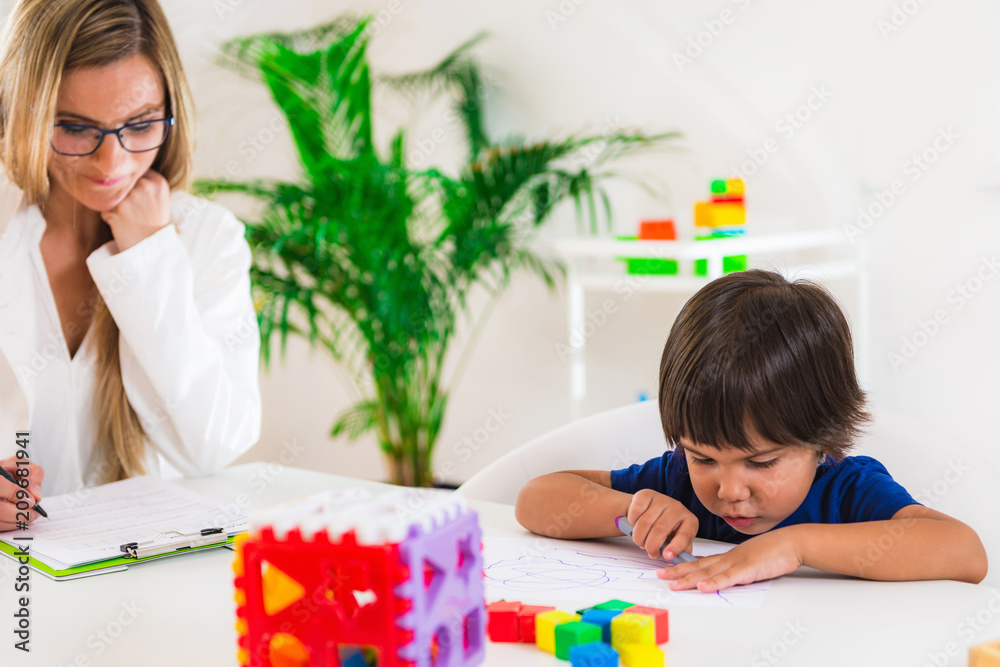 Child psychology, preschooler doing test with didactic cube