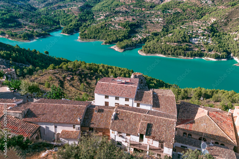 Beautiful, panoramic view of the valley and the turquoise water reservoir in the town of Guadalest in Valencia, Spain.