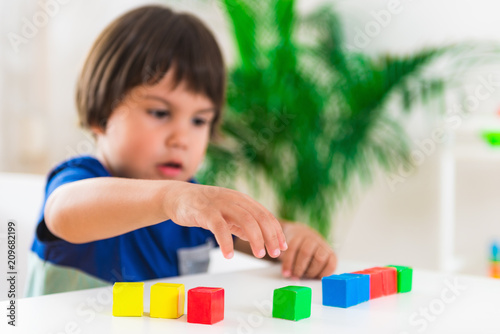 Child psychology, little boy doing test with blocks