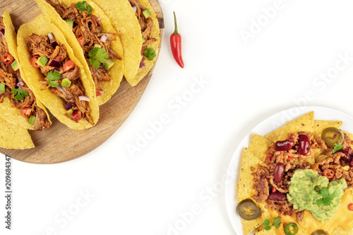 Mexican food with copy space, overhead photo of hot spicy tacos and nachos on white