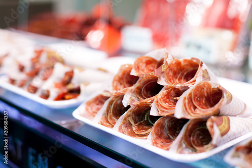 Canvas Print Parma ham or Hamon on display for sale at the Boqueria market in Barcelona