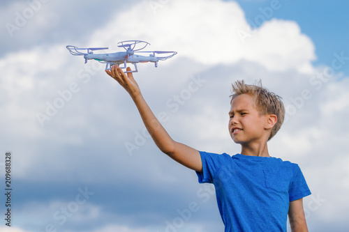 Child holding drone outdoors at summer day © vejaa