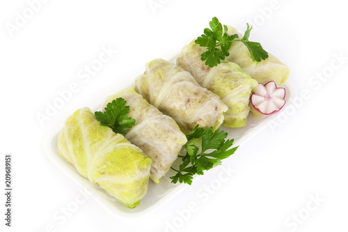 Freshly frozen semi-finished stuffed cabbage rolls.The product is packed on plastic potdtons.  Isolate on white background. photo