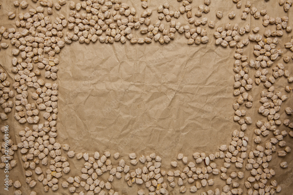 Chickpea frame on crumpled brown paper background. Top view, space for text. Chickpea frame on crumpled brown paper background. Top view, space for text.
