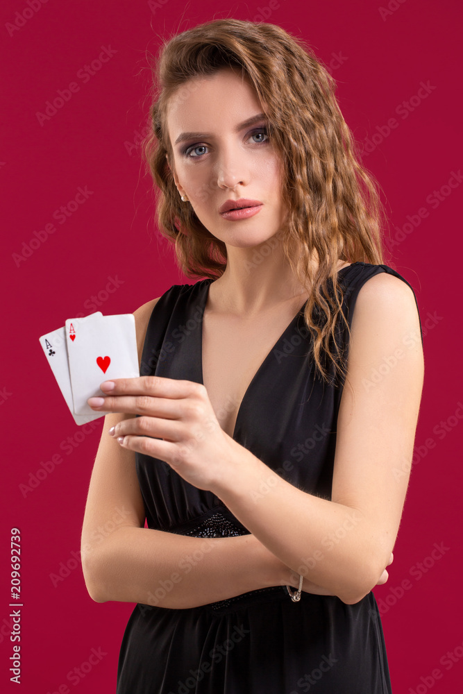 Beautiful young woman with a playing cards on red background Beautiful young woman with a playing cards on red background