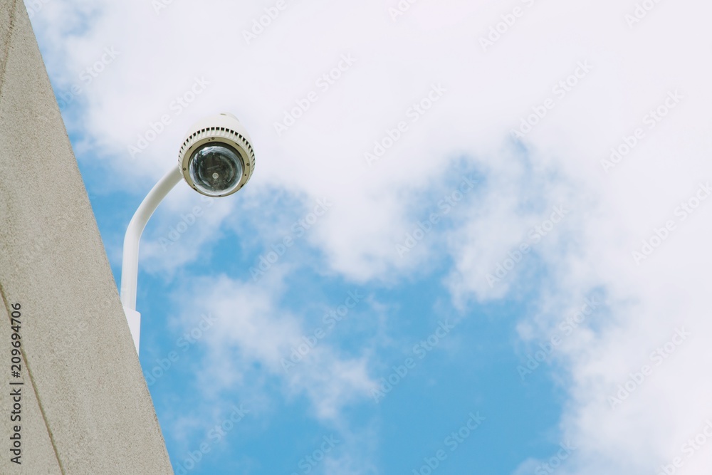Security CCTV camera office building for monitor events, top view background sky.