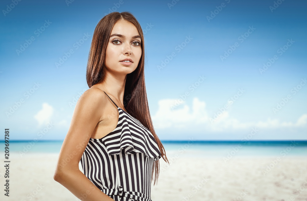 Beautiful young woman on the beach. Blurry beach and ocean background. Beautiful young woman on the beach. Blurry beach and ocean background.