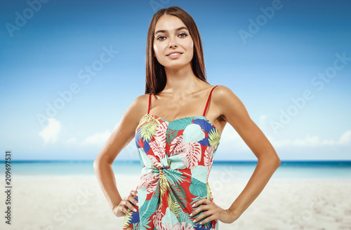 Beautiful young woman on the beach. Blurry beach and ocean background.