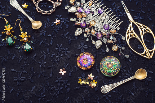 Obraz na plátně Beautiful hair accessories, scissors and buttons on a dark background