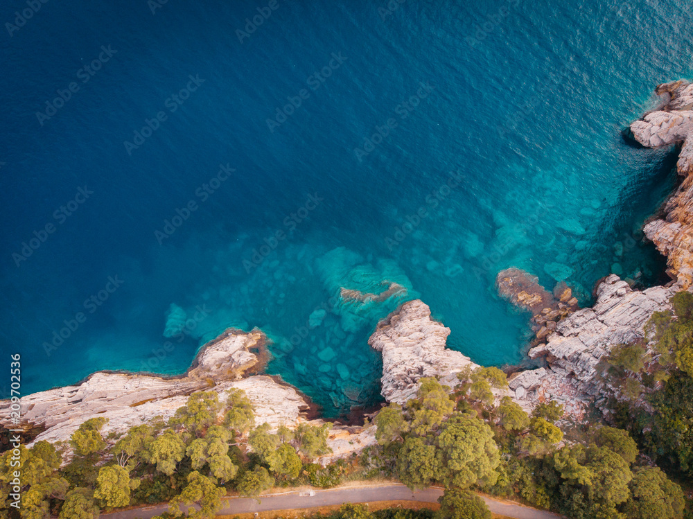 top view of the rocky shore of the crystal clear Adriatic Sea, drone shot