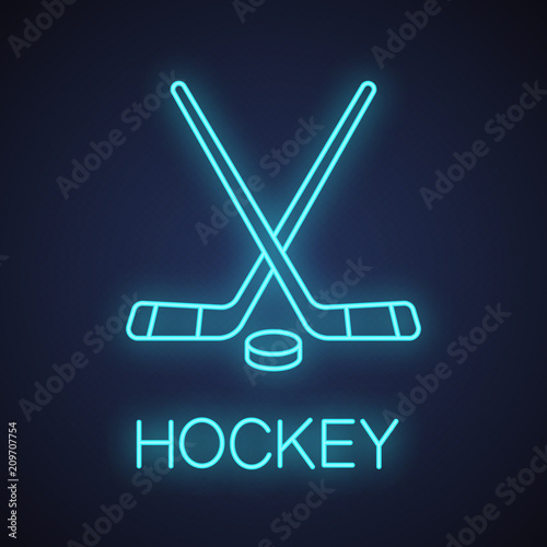Crossed hockey sticks with puck neon light icon