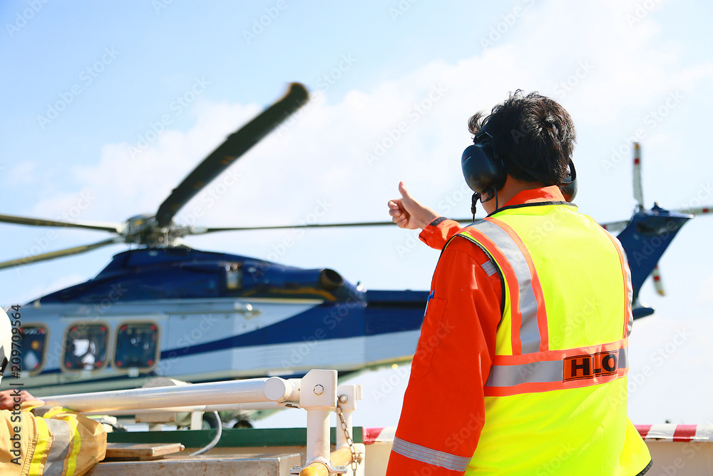 Helicopter Landing Officer communicating with pilot and copilot for