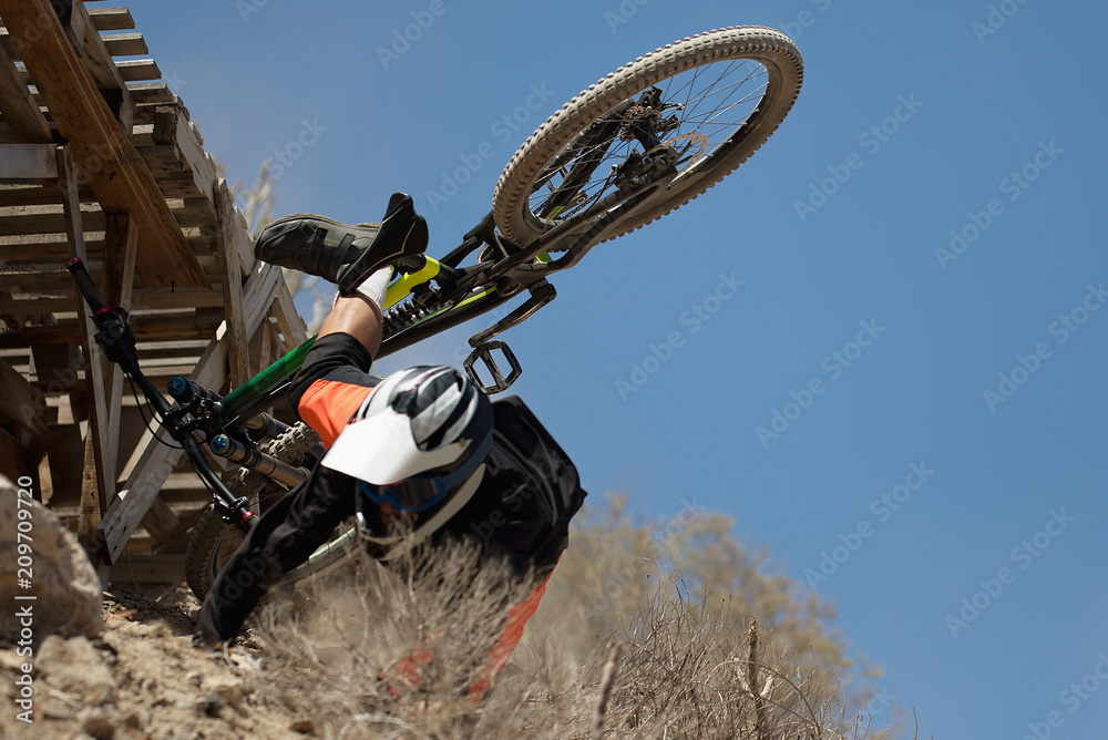 Fototapeta premium Man falls off his mountain bicycle dramatically,cyclist falls during a race