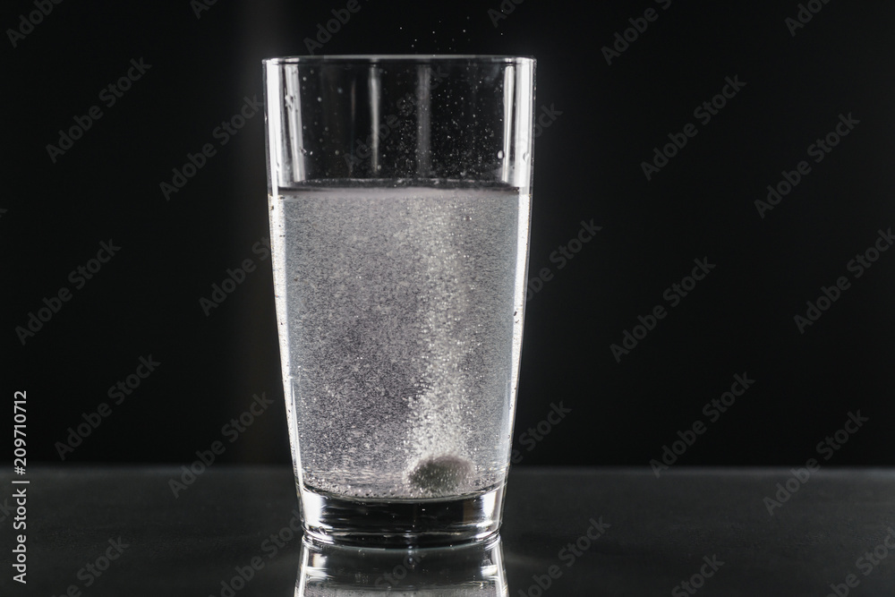 Glass of water and pills isolated on white Glass of water and pills isolated on white