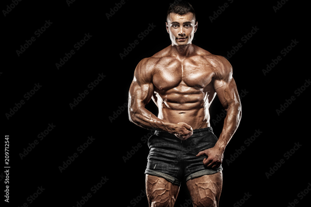 Muscular young fitness sports man. Workout with dumbbell in fitness gym. Copy space for fitness nutrition ads. Muscular young fitness sports man. Workout with dumbbell in fitness gym. Copy space for fitness nutrition ads.