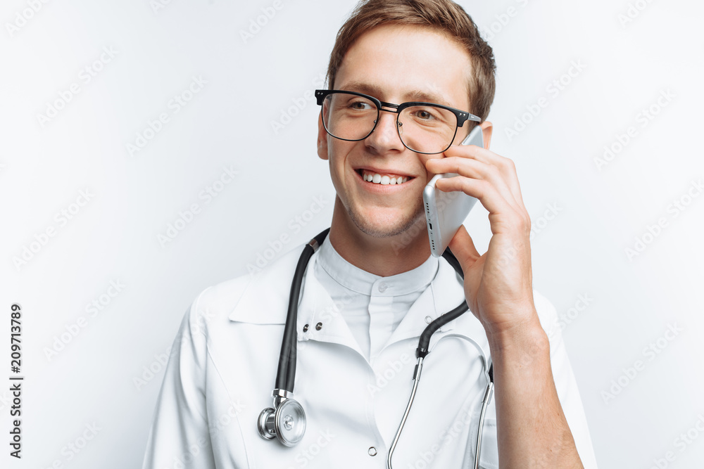 Young and handsome doctor talking on the phone with patients, Intern student with folder in hand, white background, for advertising and insertion Young and handsome doctor talking on the phone with patients, Intern student with folder in hand, white background, for advertising and insertion