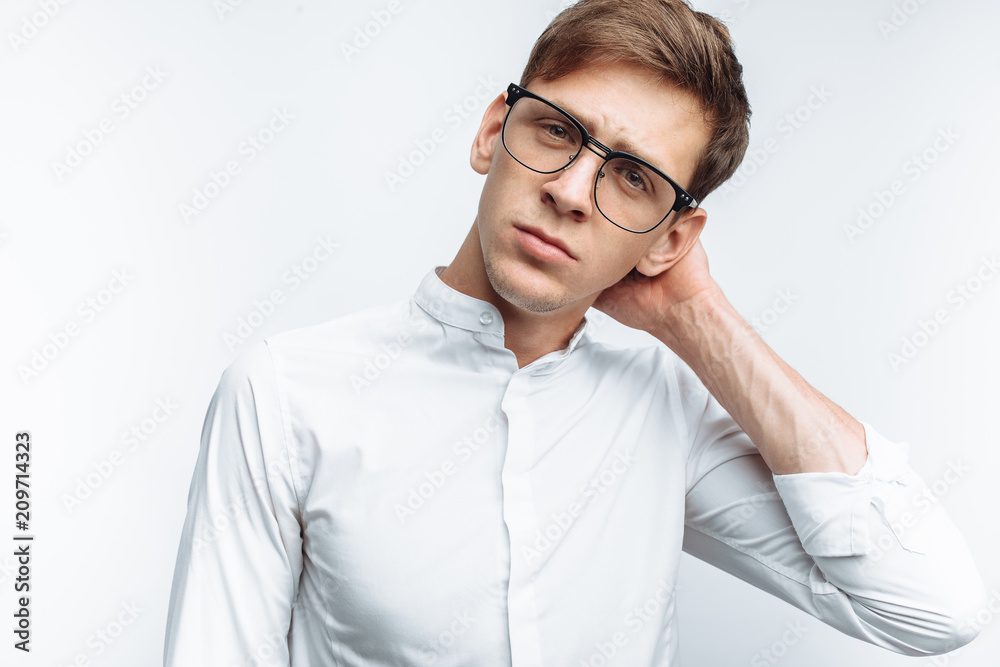 Portrait of young attractive guy in glasses, in white shirt, isolated on white background, for advertising, text insertion Portrait of young attractive guy in glasses, in white shirt, isolated on white background, for advertising, text insertion